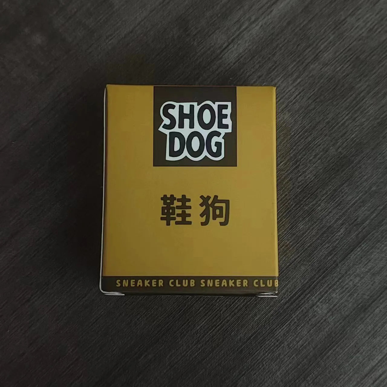 Book titled 'Shoe Dog' by Phil Knight on a wooden surface