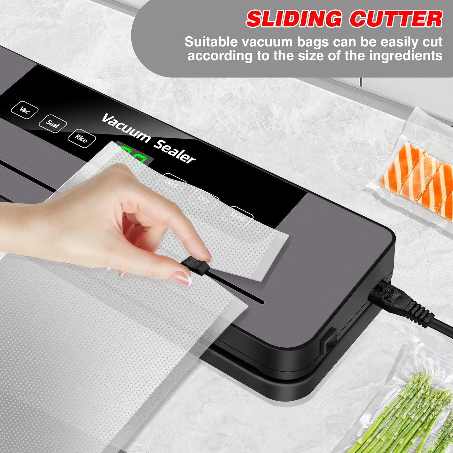 Vacuum sealer with a sliding cutter being used to cut a vacuum bag, surrounded by vacuum-sealed food items.