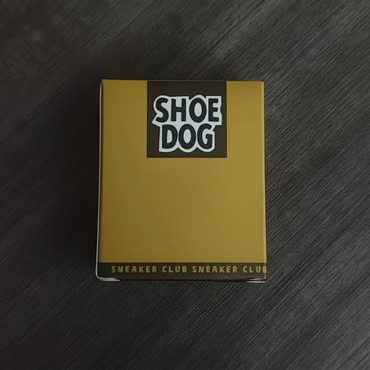 Book titled 'Shoe Dog' by Phil Knight on a dark wooden surface
