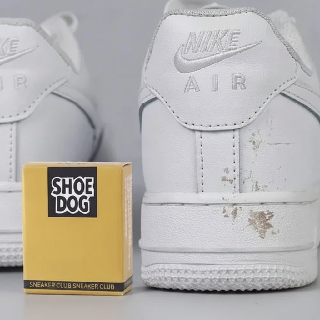 White Nike Air shoes with visible dirt, next to a yellow 'Shoe Dog' box on a gray background.